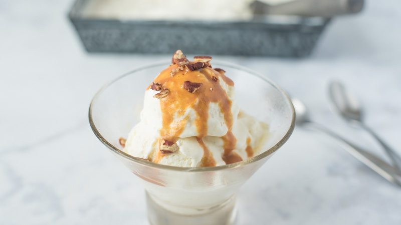 No churn vanilla bean ice cream topped with caramel and pecans