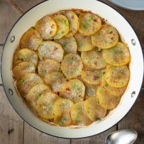 Slices of potatoes arranged decoratively in a braising pan