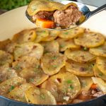 A spoonful of lamb, carrot and sliced potato