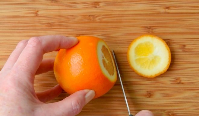 Slicing the top and bottom off an orange