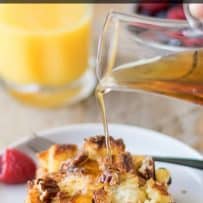 French toast casserole with a brown, crispy top with pecans and syrup