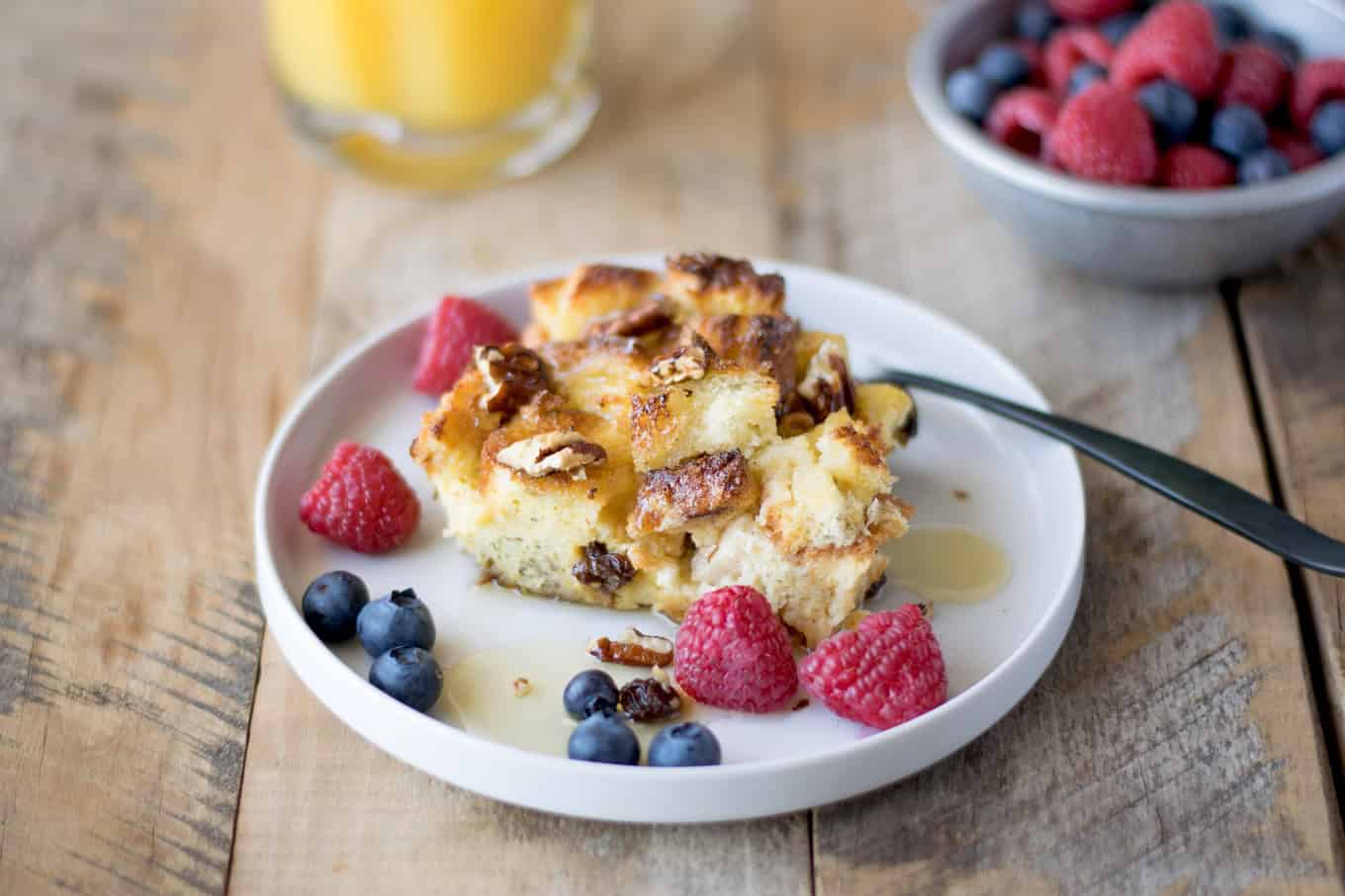 A piece of orange and apple French toast casserole with berries.