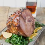 A glazed ham on a tray