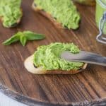 Spreading pea and mint pesto onto a crostini
