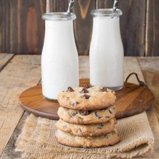 A side shot of a stack of cookies with milk