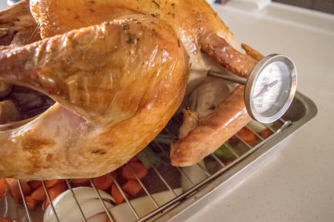 A roast turkey with a meat thermometer inserted