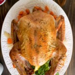 A golden brown whole roast turkey viewed from overhead