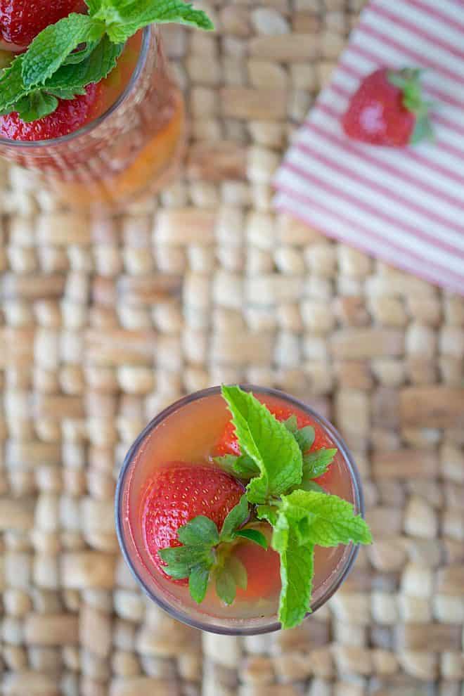The drink viewed from overhead showing the green mint leaves and beautiful strawberry