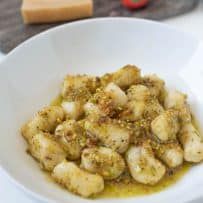 Homemade gnocchi served in pistachio pesto