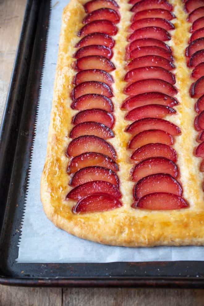A closeup of a plum tart showing the pretty slices