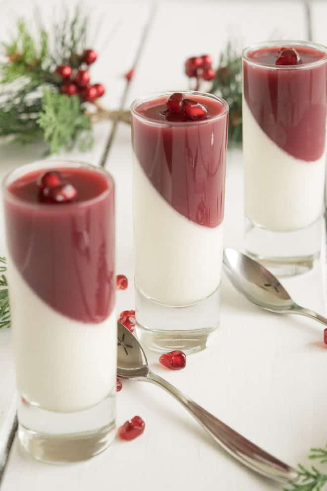 3 small glasses of pomegranate panna cotta with spoons
