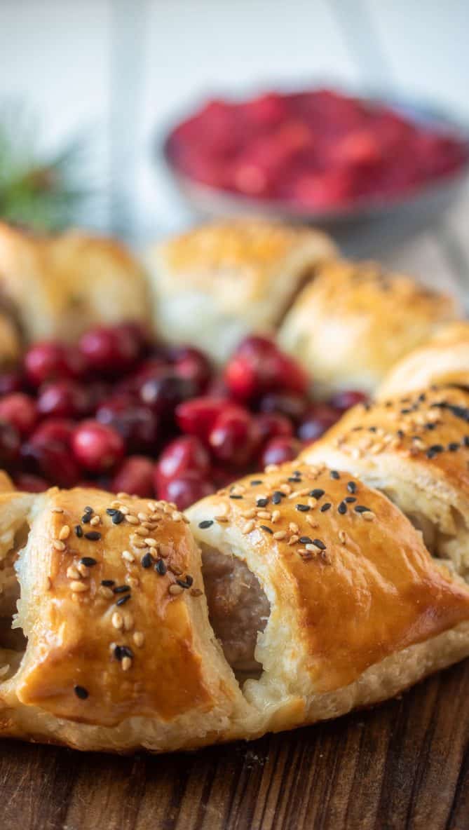 A closeup of the sausage roll wreath with cuts showing the sausage inside