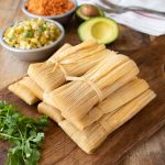 Tamales with fresh cilantro, corn, rice and avocado