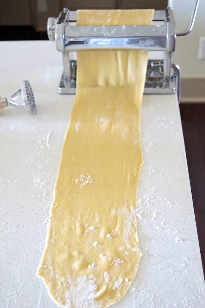 Rolling fresh pasta through a pasta maker