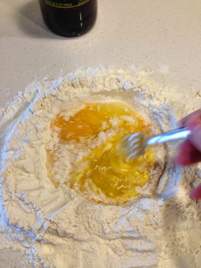 Whisking eggs into flour