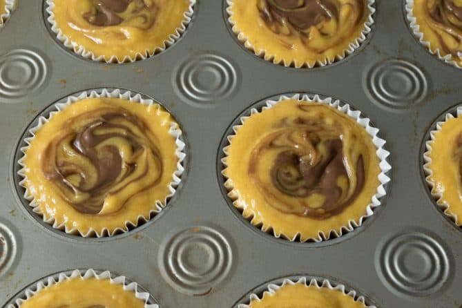Nutella being swirled into muffin mix before baking