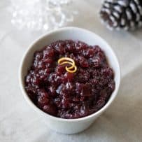 Dark red, chunky cranberry sauce in a white bowl