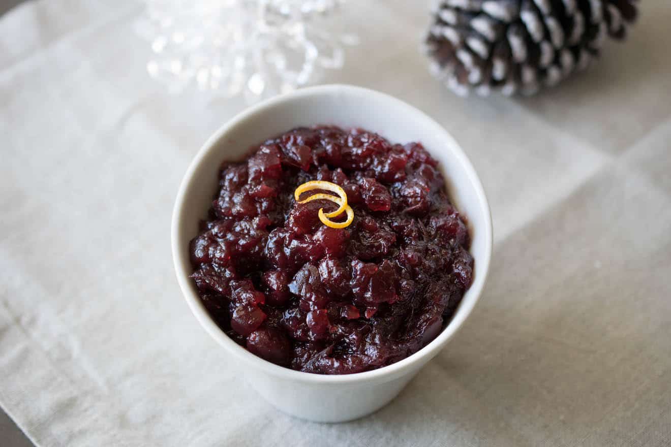 Dark red, chunky cranberry sauce in a white bowl