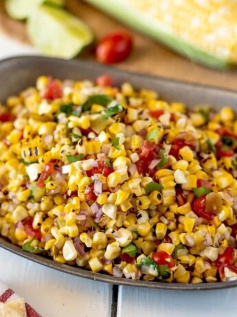 Corn kernels with tomato and chiles in a bowl