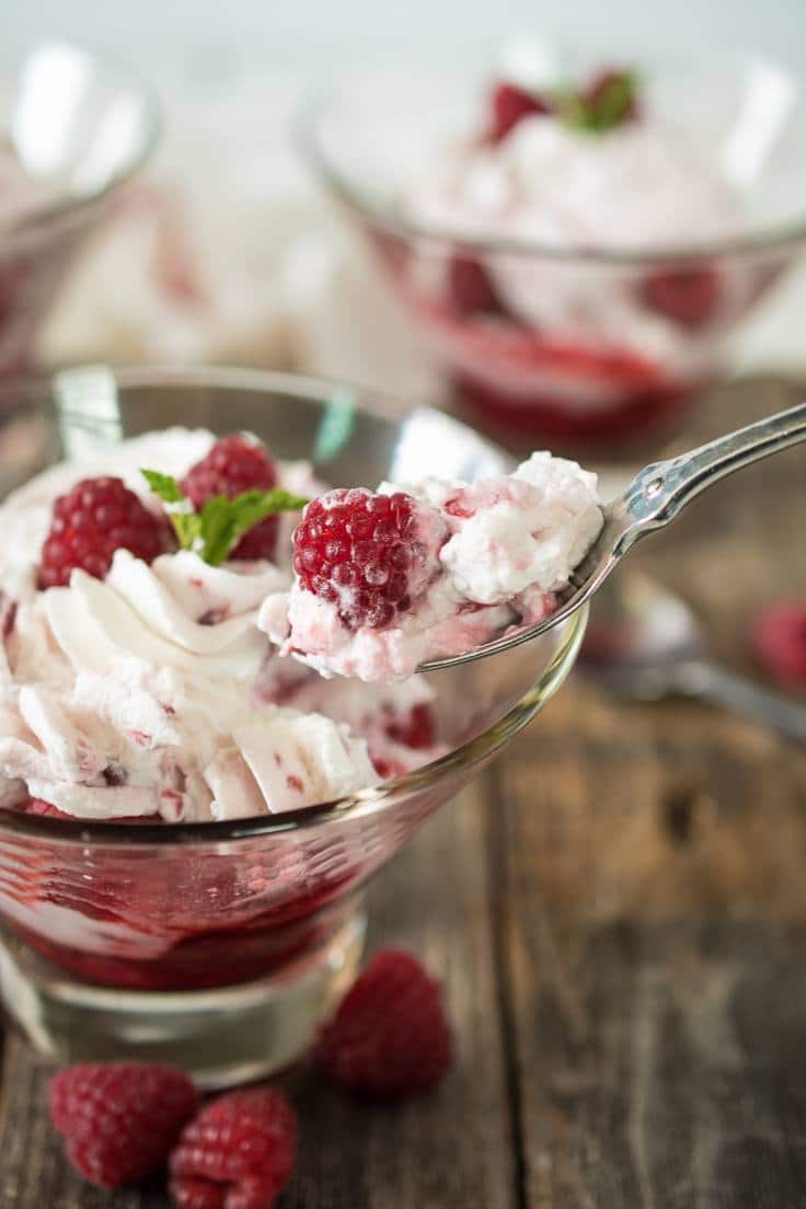 The perfect bite of a raspberry fruit fool, a spoonful of fresh cream and raspberries