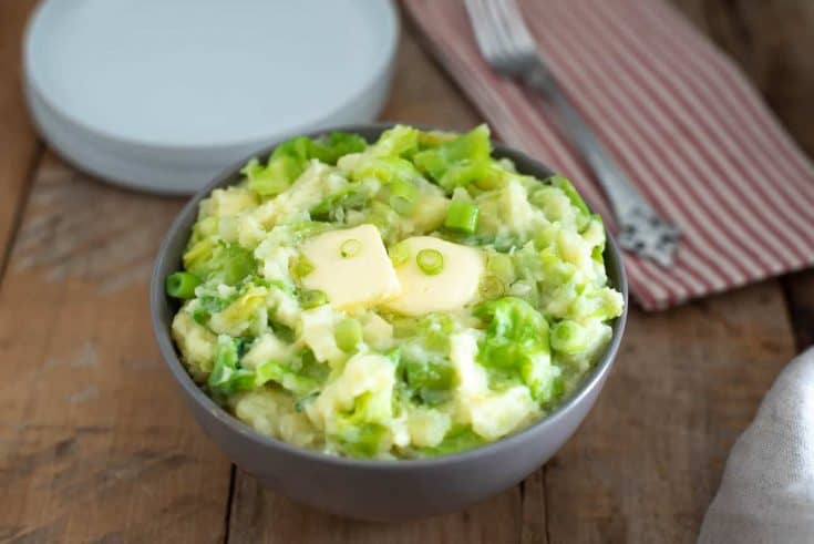 A large bowl of mashed potato mixed with green cabbage, spring onion, Irish cheddar and Irish butter
