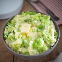 Irish colcannon with large pieces of cabbage and spring onion topped with melted butter