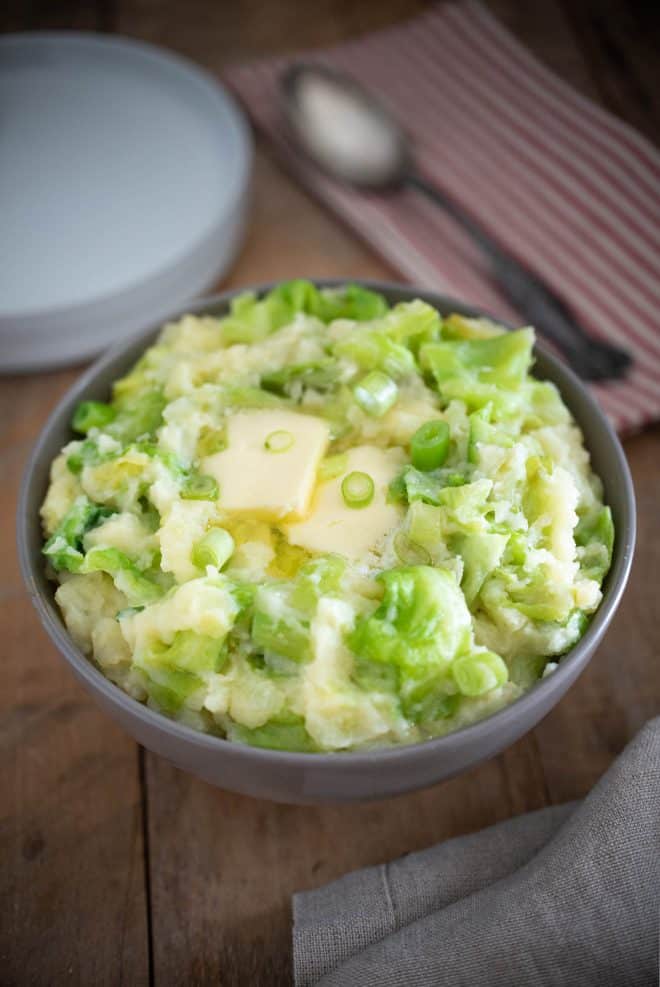 Irish colcannon with large pieces of cabbage and spring onion topped with melted butter
