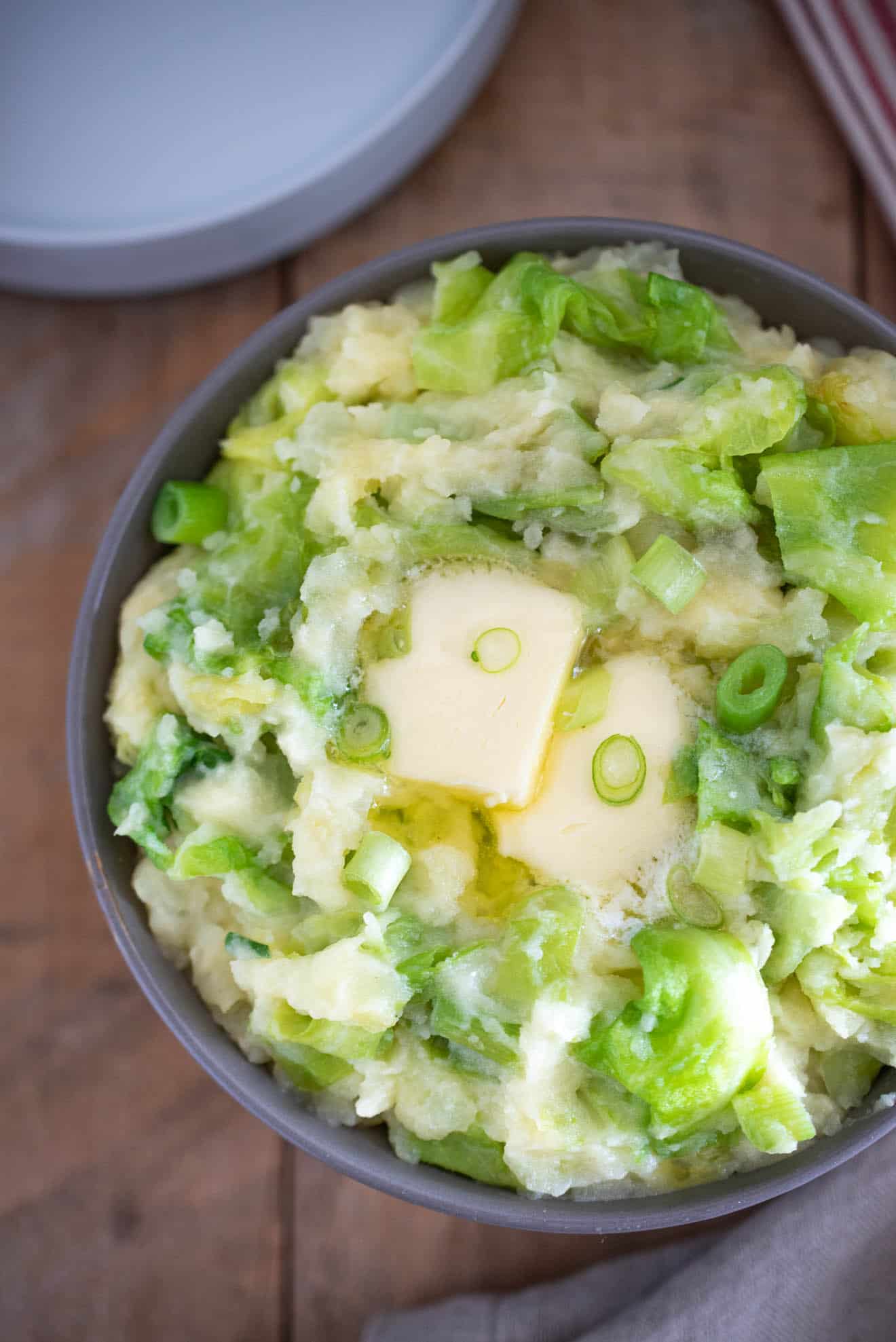 A closeup of the colcannon showing the melting butter, cabbage and spring onion