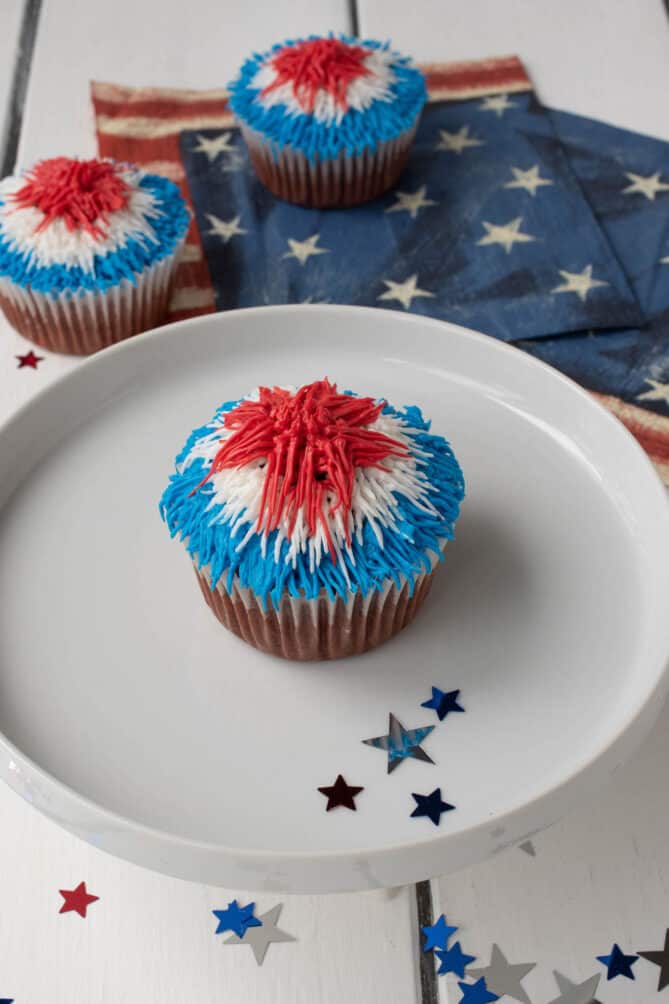 Firework red white and blue frosting on a red velvet cupcake