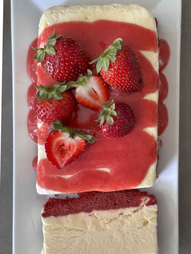 An overhead view of an ice cream cake with fresh strawberries