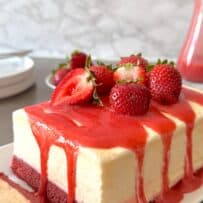 Fresh strawberry sauce running down the sides of an ice cream cake
