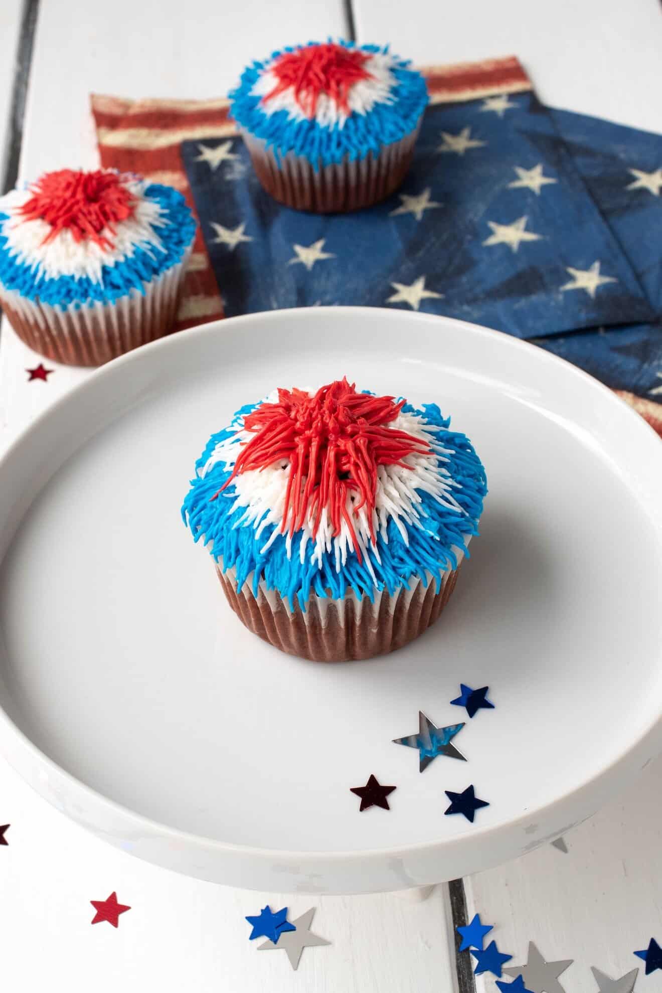 A selection of red white and blue cupcakes on a white stand
