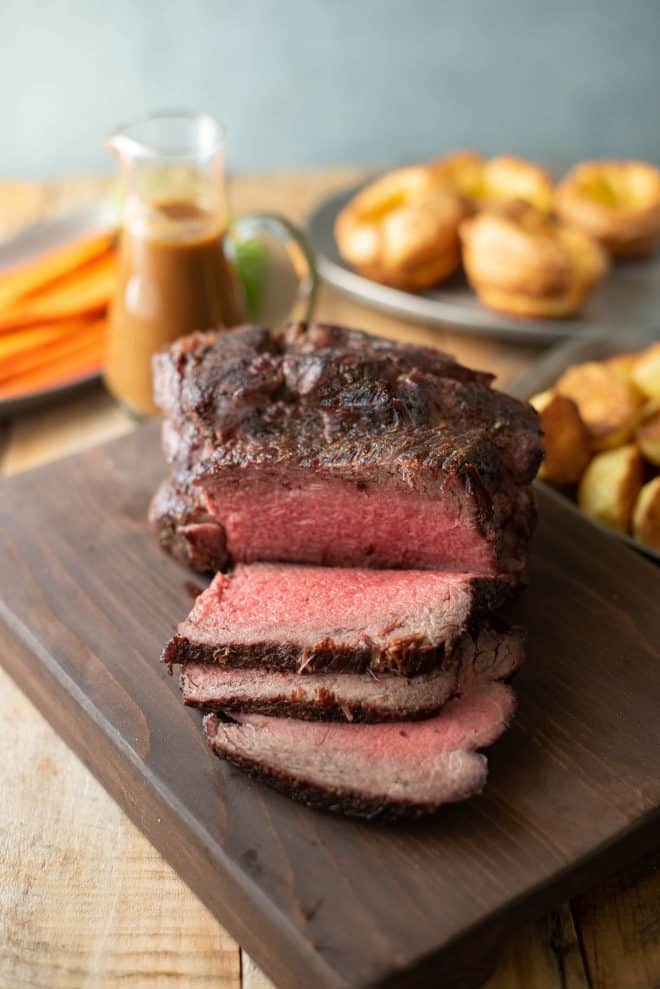 Perfectly cooked roast beef sliced on a cutting board