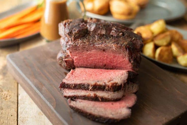 Sliced roast beef on a serving board