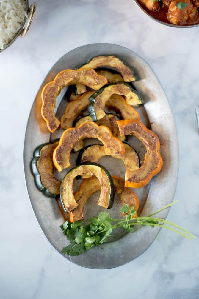 An oval plate of roasted acorn squash viewed from overhead