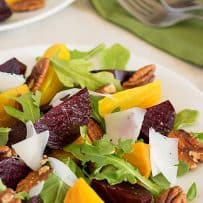 Red and gold beets cut into wedges with arugula, pecans and parmesan