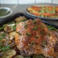 A boneless leg of lamb studded with fresh rosemary on a bed of potatoes and fennel