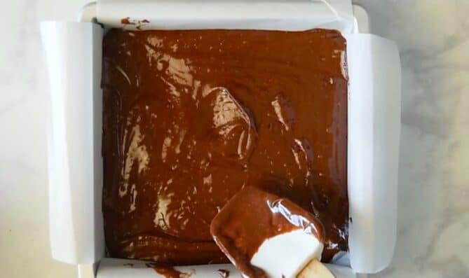 Brownie batter in a square baking pan
