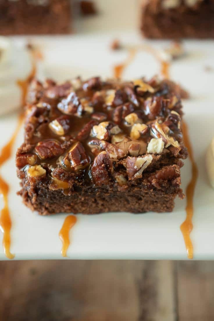 Salted caramel drizzled all over a slice of pecan brownies