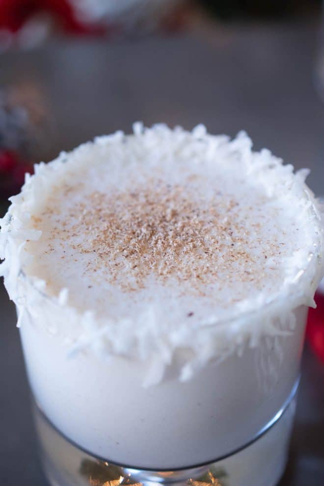 A closeup of Santa's Rum Spiced Milk showing the coconut rim and nutmeg garnish