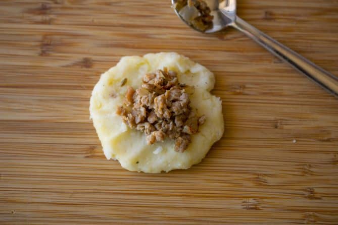 Mashed potato topped with sausage meat