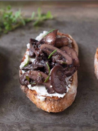3 sautéed mushroom and rosemary bruschetta on a serving platter