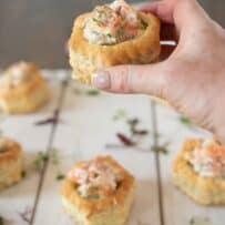 Holding a shrimp and avocado puff pastry shell