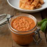 A jar filled with Sicilian Tomato Pesto Sauce