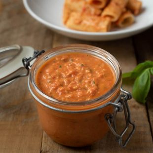 A jar filled with Sicilian Tomato Pesto Sauce