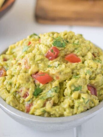 Signature guacamole with fresh tomatoes and cilantro