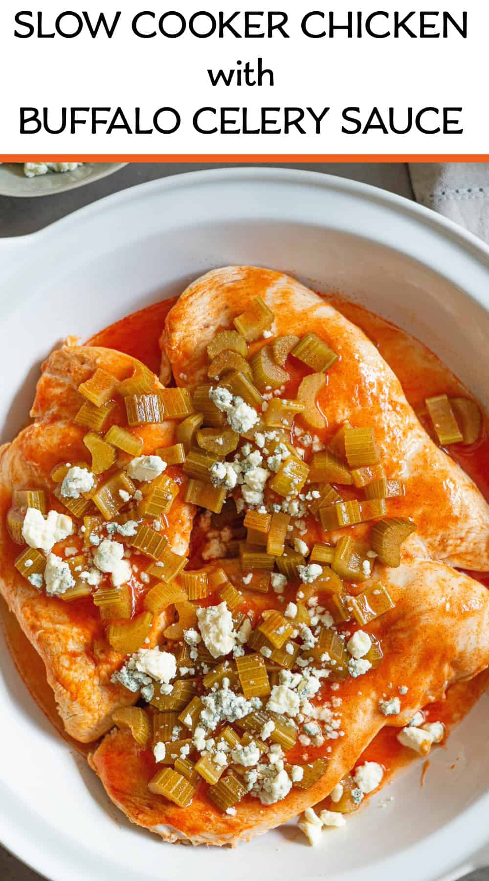 3 chicken breasts in a white bowl coated with sauce and blue cheese