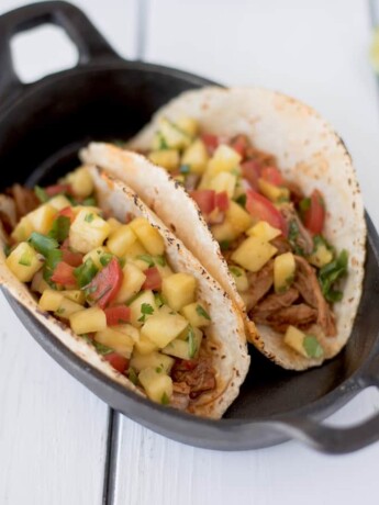 2 carnitas pork tacos with pineapple salsa