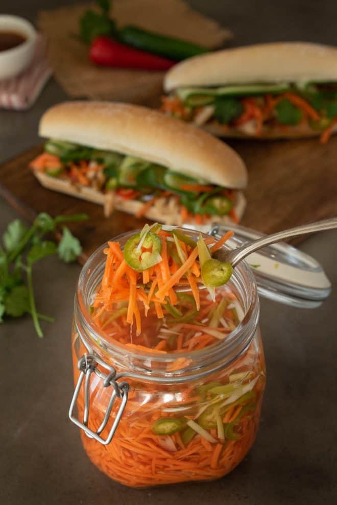 The spicy carrot slaw with spring onion and jalapeño on a fork