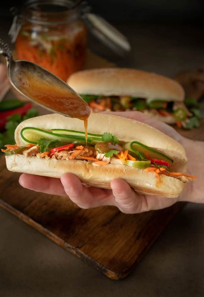 Drizzling the delicious sauce on banh mi